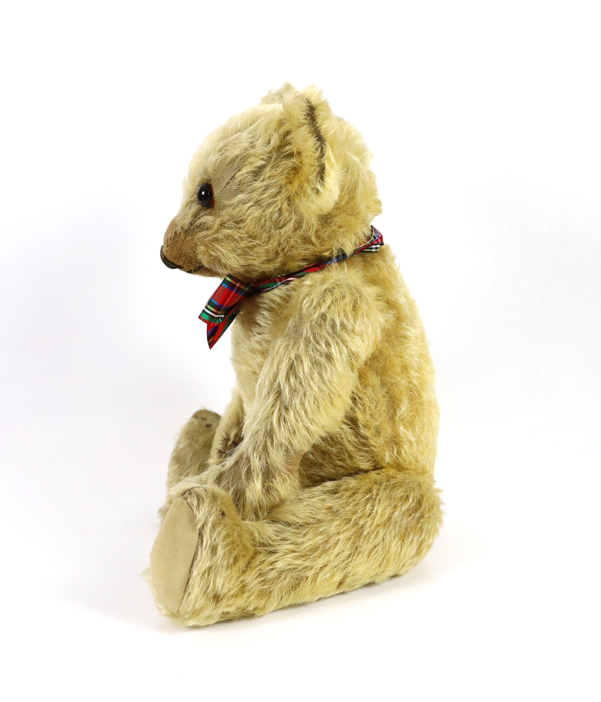 A 1930's Merrythought bear, with label, 44cm, old repair to foot, some hair loss